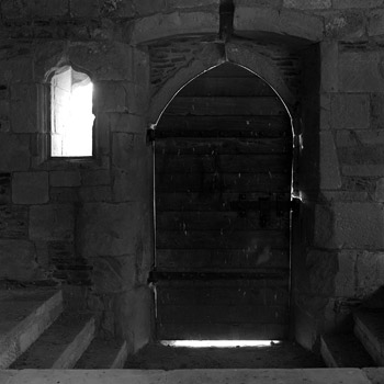 A line of light around a wooden gothic door